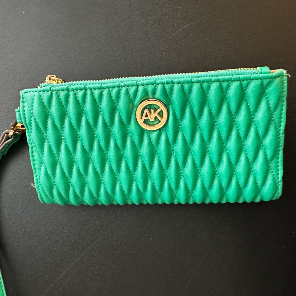 Anne Klein puffy vibrant green wallet with ample room. 
NWOT  never used.